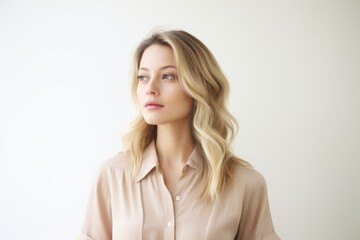 Portrait of a beautiful young blonde woman in a pink shirt.