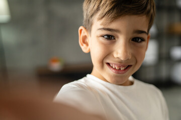 One boy caucasian child seven years old kid at home schoolboy portrait