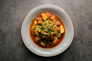 Portion of oriental stewed meat dish with potatoes