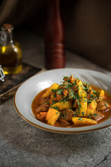 Portion of oriental stewed meat dish with potatoes