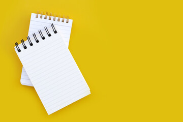 To do list note book on yellow background.