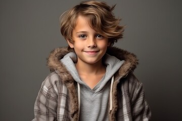 Portrait of a cute little boy in a warm coat. Studio shot.