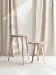 Two wooden geometric shape brown chairs with different height in sunlight, leaf shadow on beige...