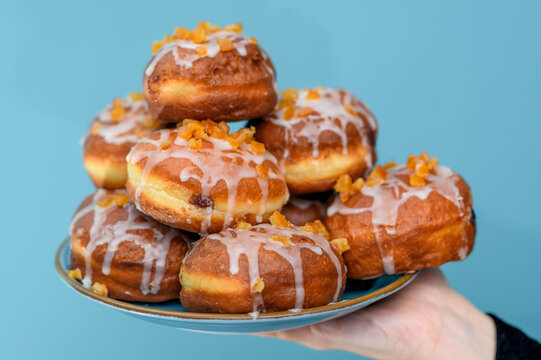 Pączki duża ilość na talerzu z dżemem, lukrem I skorka pomarańczową
