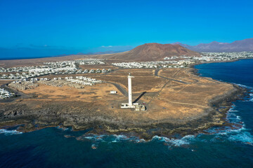 Drone photography of the lighthouse Faro de Punta Pechiguera and the beautyful playa blanca. Aerial...
