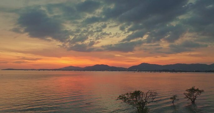 aerial view reflection of colorful cloud in bright sky of sunset above the ocean at Khao Khad Phuket. 
Majestic sunset or sunrise landscape Amazing light of nature background. 
fantastic sky texture.