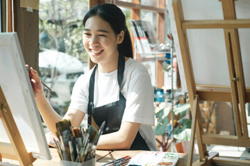 Crafting Inspiration: Female Artist Sketching and Painting in Workshop