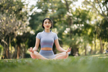 Portrait of young woman practicing yoga in garden.female happiness.  in the park blurred background.
