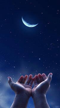 Praying muslim, hands open to the sky in the holy night. Social media story, vertical