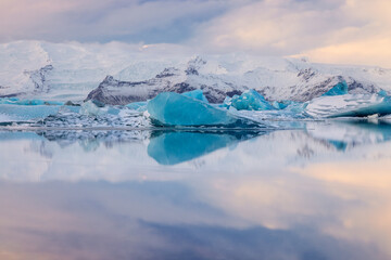Blue heart-shaped iceberg reflection at Jokulsarlon Glacier lagoon in Iceland
