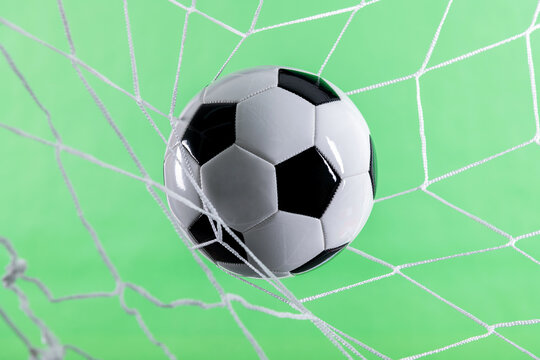 Soccer ball goal success on green background