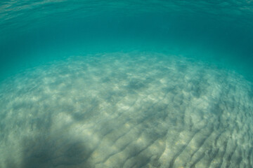 Fototapeta na wymiar Deep blue ocean sand floor view.