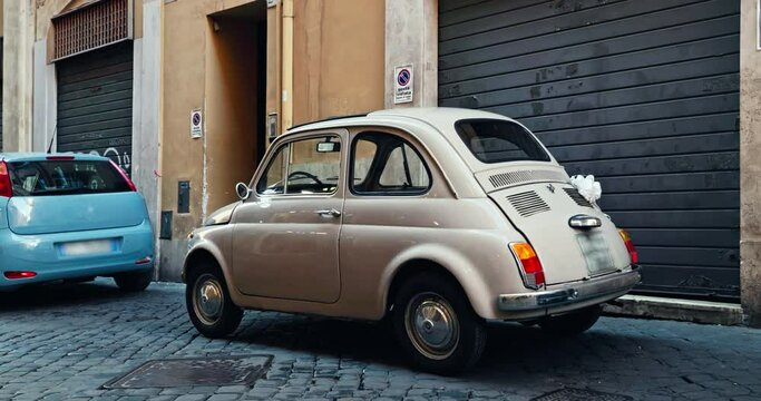 Beautiful cars parked on the narrow streets of Rome, Italy. Cityscape traffic on roads. High quality 4k footage