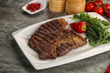 Grilled chuck roll steak with arugula