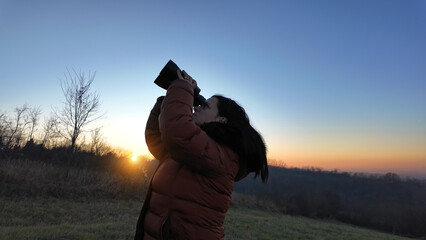Amateur astronomer observing skies with binoculars.
