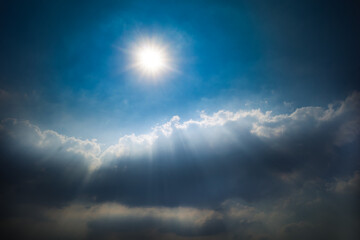 Bright beam and rays of light from the sun Trying to break through the dark cloudy in the sky,...