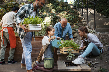 Volunteers at neighbourhood project planting herbs in community garden