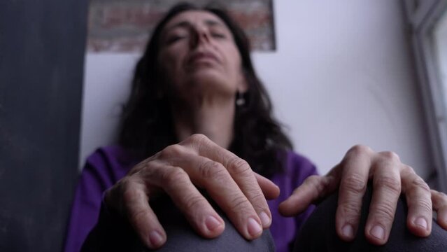 Adult Woman moving her fingers with anxiety while Coping Alone with Stressful Emotions.