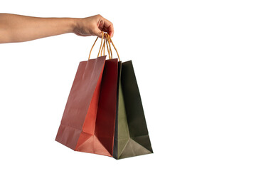 Red and green paper shopping bag in hand on transparent background.