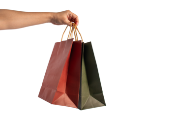 Red and green paper shopping bag in hand on transparent background.