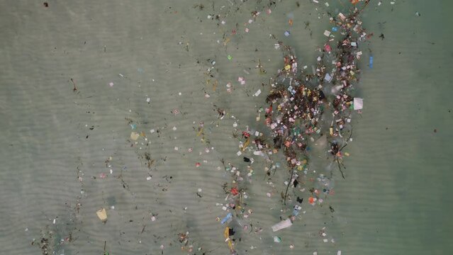 Aerial view of severe water pollution with plastic and debris accumulation in the sea (Phu Quoc, Vietnam)
