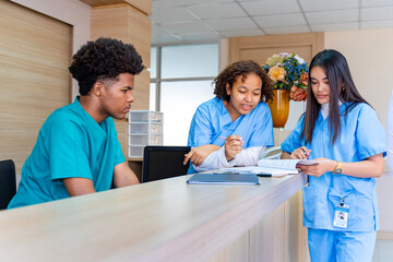 Team of diversity doctor and nurse is discussing and brainstorming over patient medical record after diagnosis for precise care plan with experienced senior physician specialist
