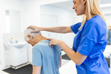 Licensed chiropractor or manual therapist doing neck stretch massage to relaxed female patient in...