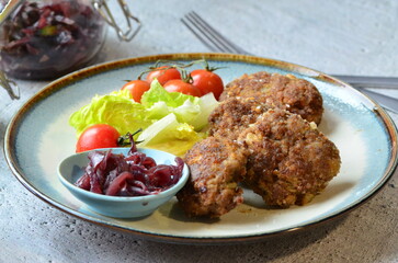 Fried meatballs with vegetables on the table. Selective focus.