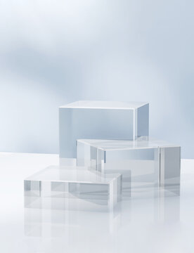 Fototapeta Three modern transparent cuboid podium, geometric pedestal on white counter, dappled light on blue wall. Luxury cosmetic, skincare, beauty, body care, treatment, fashion product display background 3D