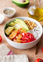 Bowl with rice, shrimp, avocado, tomato, chickpeas and lime. Healthy eating. Diet.