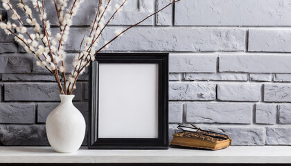 Mock up black frame and dry twigs in vase on book shelf or desk. White colors.