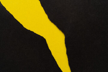 Fototapeta na wymiar 破れた黒い紙に黄色背景