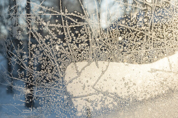 Frosty window on a freezing and sunny day