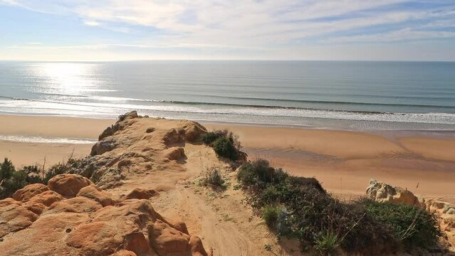 Arenosillo beach, located in Huelva, Spain. Explore the serene beauty of this coastal paradise with its sunlit sandy shores and the rhythmic ebb and flow of the Atlantic Ocean.