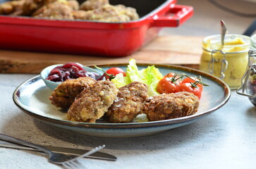 Meatballs with salad and cherry tomatoes on a plate. Selective focus.