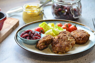 Meatballs with salad and cherry tomatoes on a plate. Selective focus.