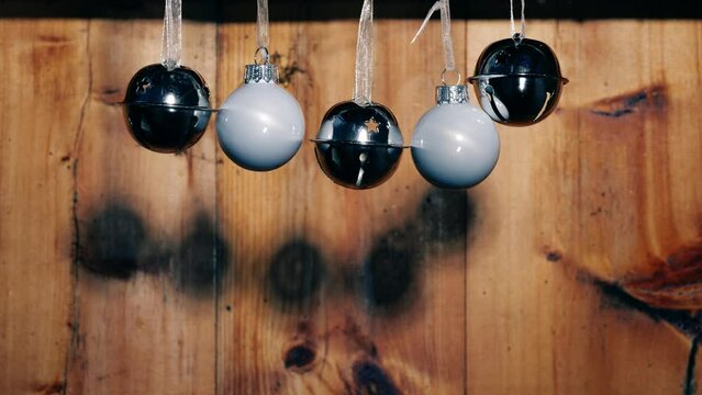 Silver Christmas bells on rustic wooden background