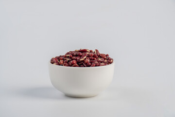 Red kidney beans in white cup on white background