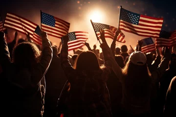 Fotobehang group of people waving american flags in back lit © Muhammad
