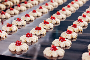 Modern line for bakery cookies with red jam. Food industry, biscuit production in factory on conveyor belt