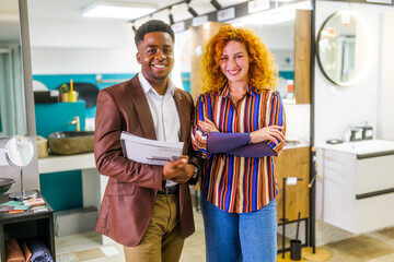 Portrait of young couple who owns small business bath store. Man and woman work in partnership.