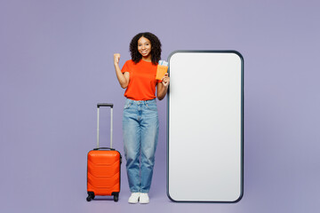 Traveler kid teen girl wear orange t-shirt hold bag passport ticket big huge blank screen area...
