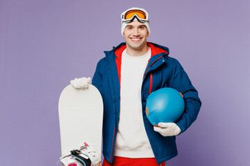 Smiling happy fun man wears warm blue windbreaker jacket ski goggles mask hat hold snowboard...