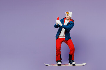 Full body man wear blue windbreaker jacket ski goggles mask hat snowboarding taking picture on...