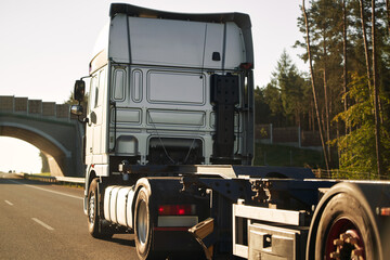 A truck transports cargo containers transported on land with semi trailers. Highway shipping and post delivery. Global commerce and industry that uses sustainable efficient logistics systems.