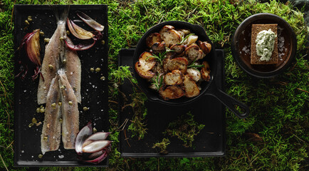 Herring fillet with capers, salt flakes, red onion and pepper, potatoes with forest mushrooms and...