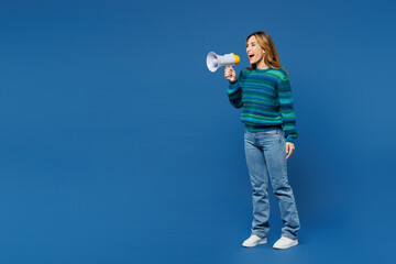 Full body young woman she wears knitted sweater casual clothes hold in hand megaphone scream...