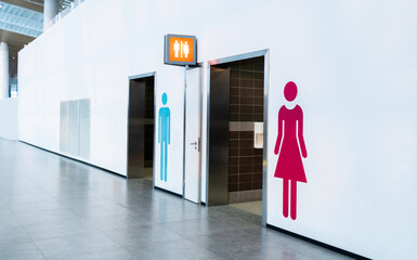 Men and women toilet sign on the wall - Powered by Adobe