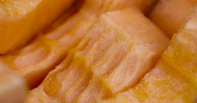 sliced orange melon close-up, delicious soft and ripe food melon on the table