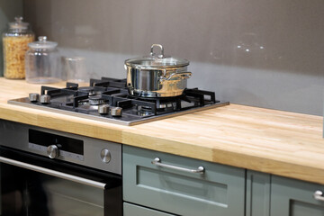 wooden kitchen countertop with hob gas stove